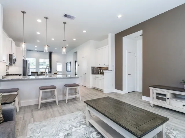 a living room with furniture and wooden floor