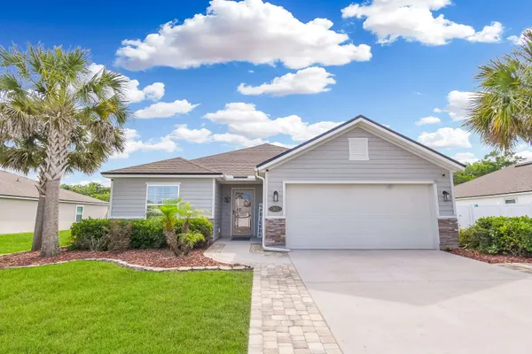 a view of a house with a yard and plants