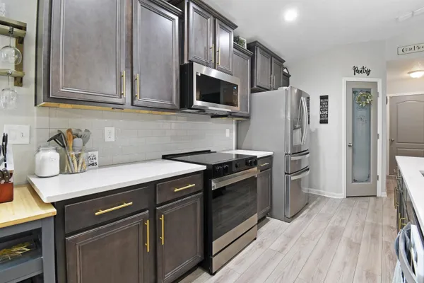 a kitchen with stainless steel appliances granite countertop a sink stove and refrigerator