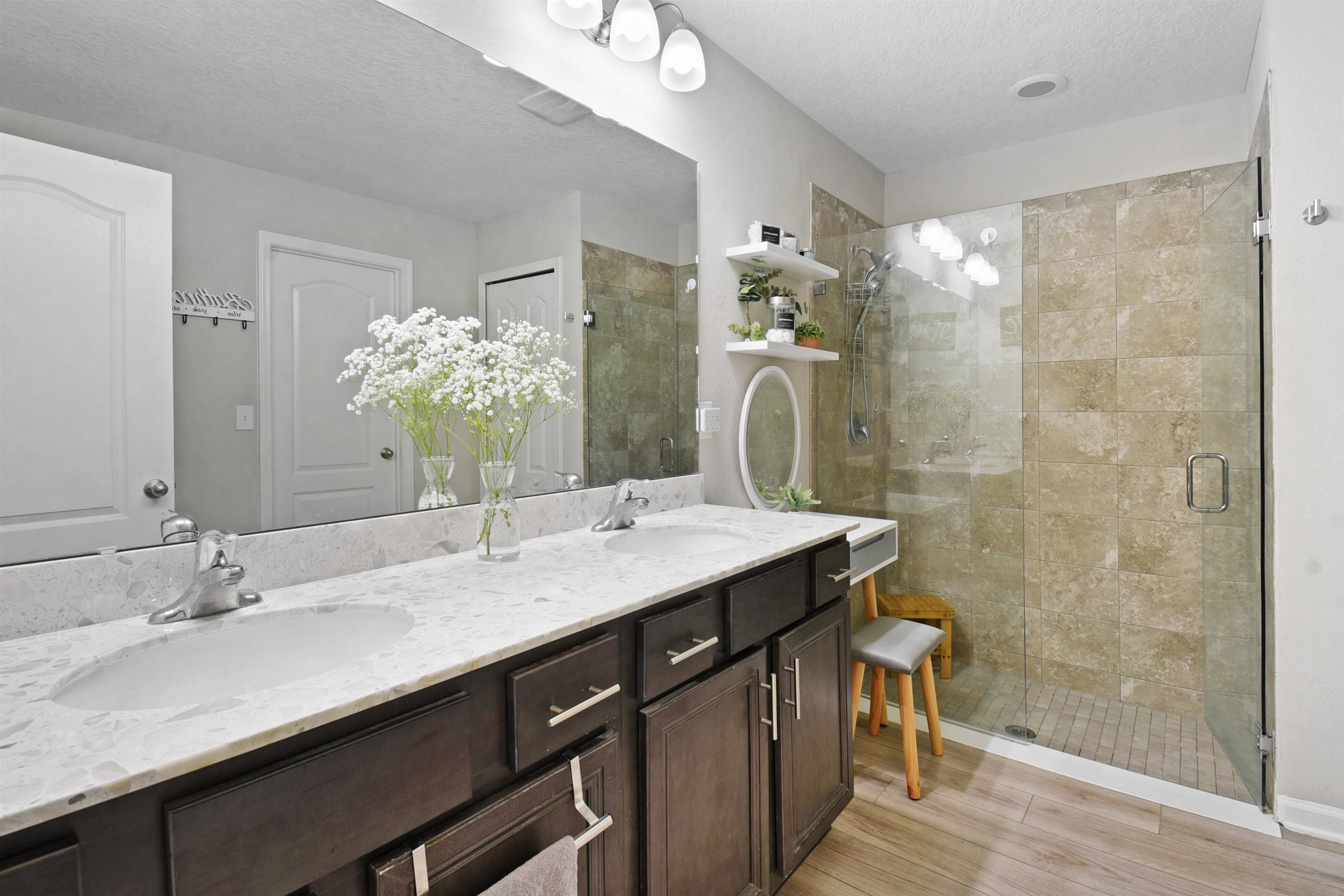 362 South Hamilton Springs Road St. Augustine, FL 32084 - Photo 18 of 37 a bathroom with a granite countertop sink a mirror and a shower