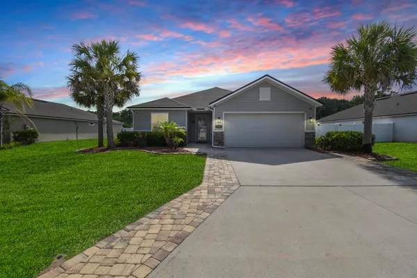 a front view of house with yard and green space