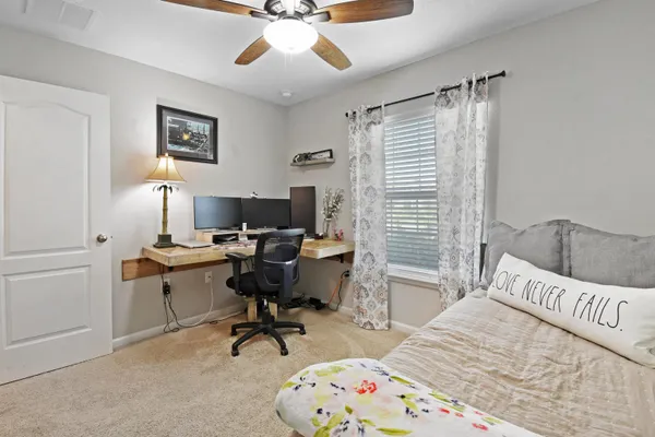 a bedroom with a bed and a desk