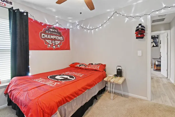 a bedroom with a bed and a chandelier