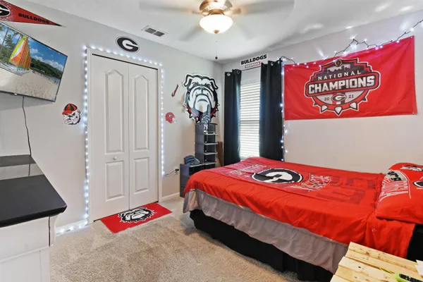 a bedroom with a bed and a chandelier