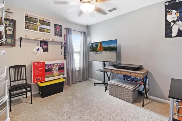 a bathroom with a granite countertop sink toilet and a mirror