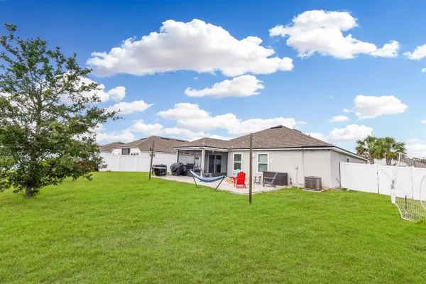 a front view of a house with a garden and plants