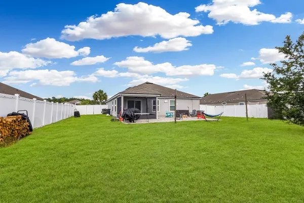 a view of tall trees and a big yard