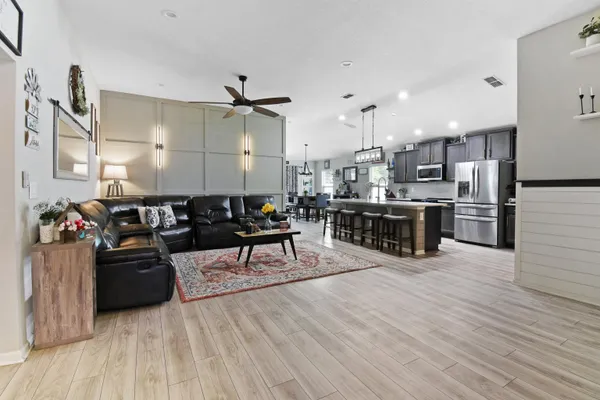 a living room with lots of furniture and kitchen view