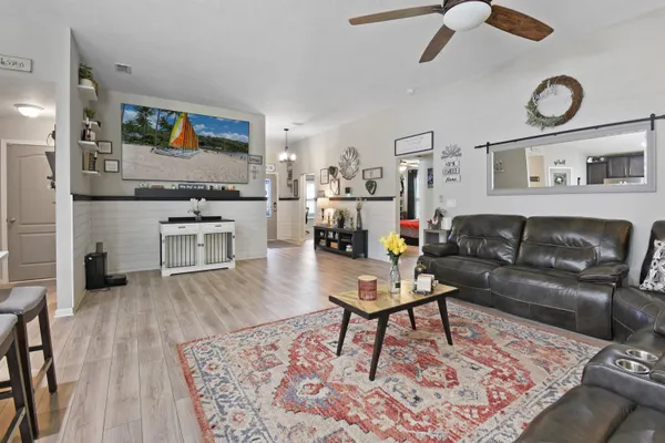 a living room with furniture and wooden floor