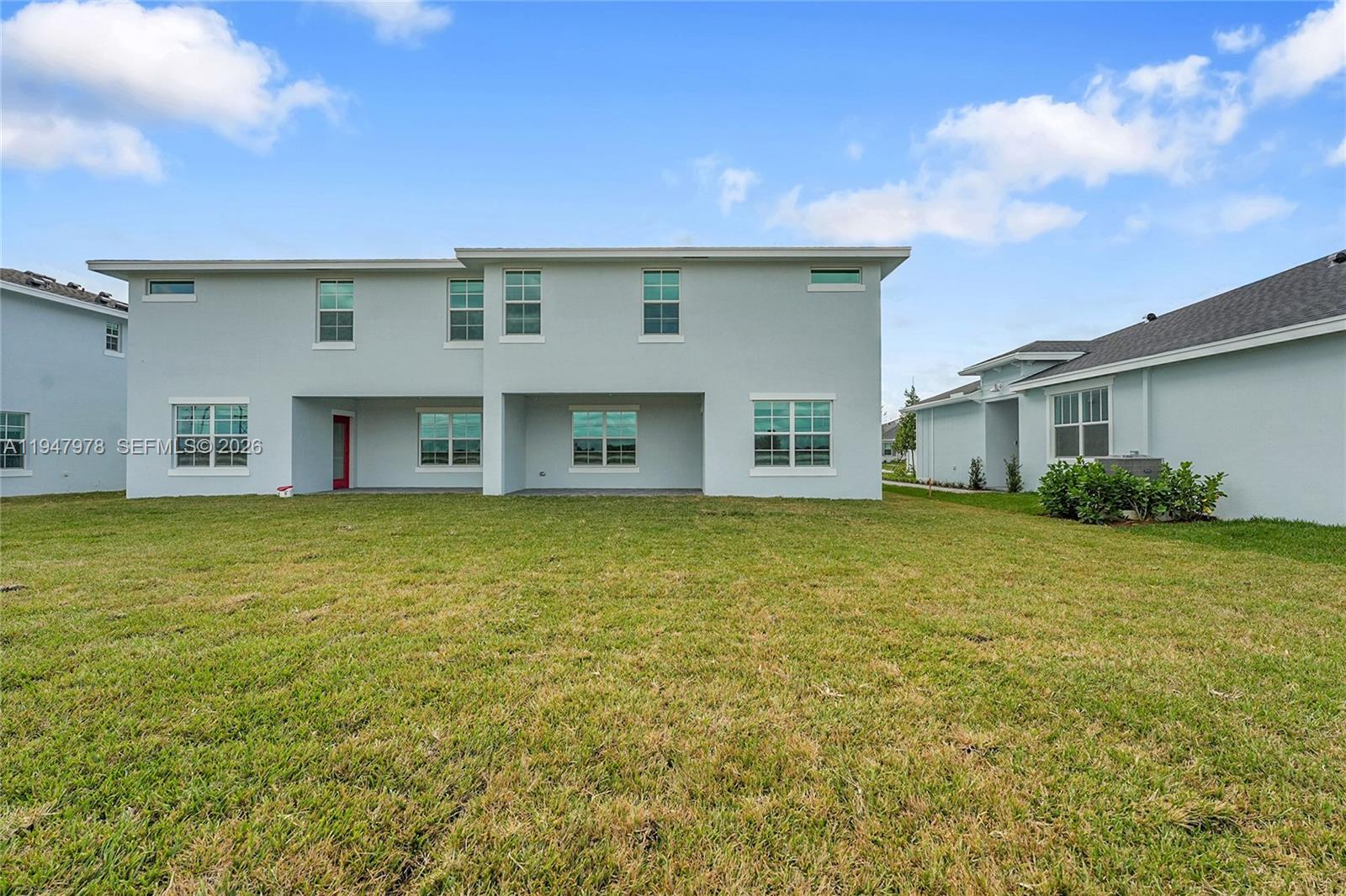 19560 Whispering Creek Road, Unit 19560 Loxahatchee, FL 33470 - Photo 13 of 19 a front view of a house with a garden