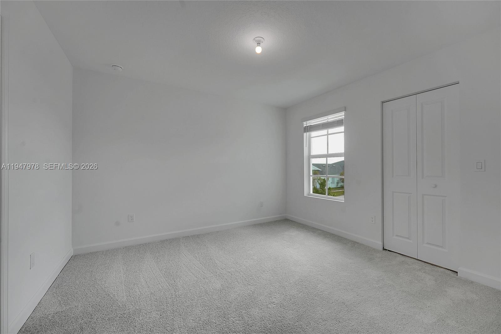 19560 Whispering Creek Road, Unit 19560 Loxahatchee, FL 33470 - Photo 9 of 19 an empty room with windows