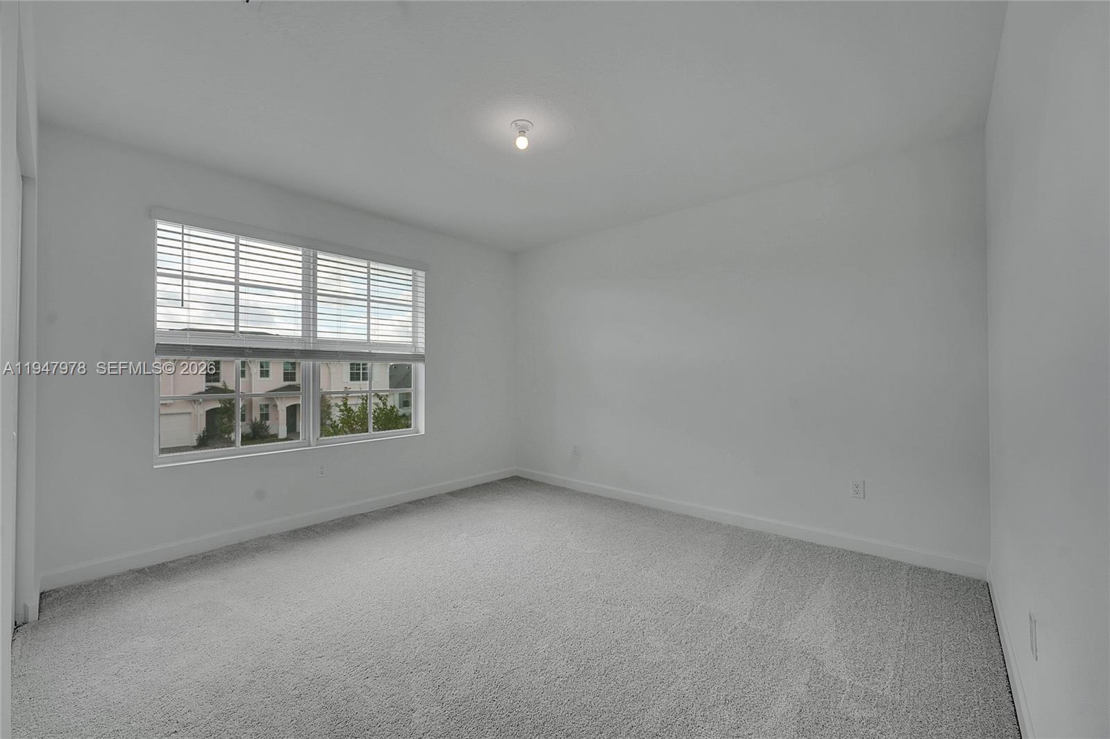 19560 Whispering Creek Road, Unit 19560 Loxahatchee, FL 33470 - Photo 10 of 19 an empty room with a window