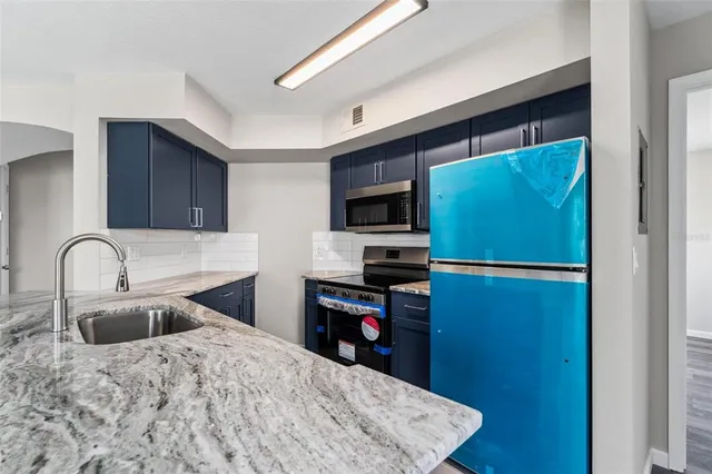 a kitchen with a refrigerator and a sink