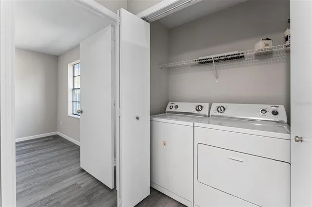 a utility room with cabinets washer and dryer