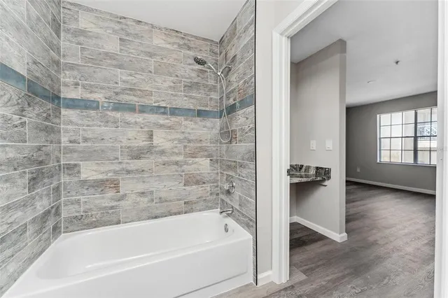 a bathroom with a bathtub and window