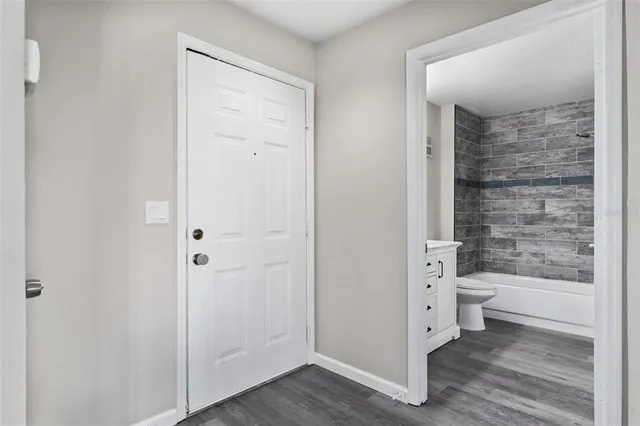 a bathroom with a granite countertop toilet a sink and shower