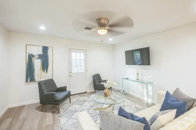 a living room with furniture and a flat screen tv
