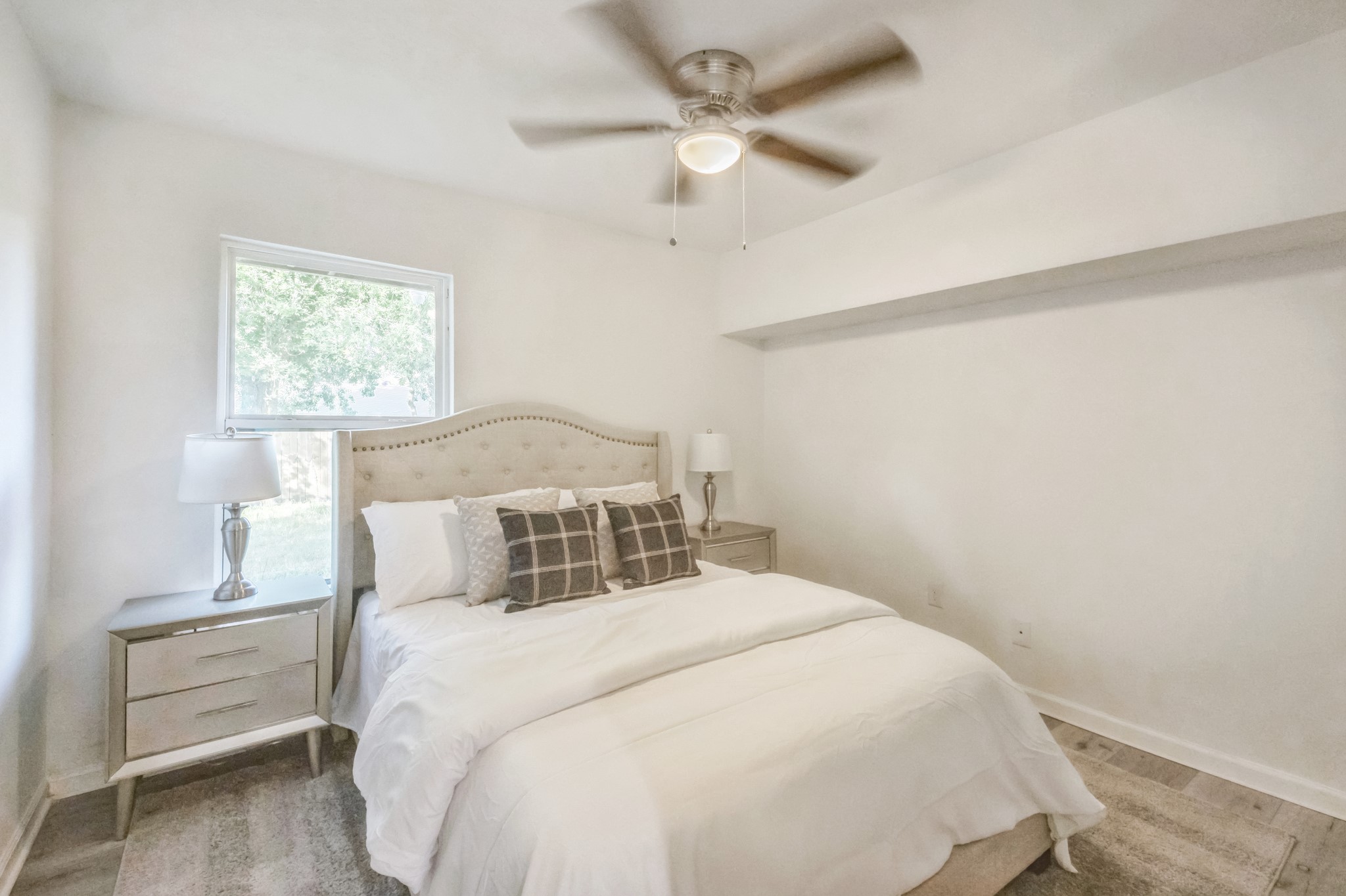 5236 Perry Street Houston, TX 77021 - Photo 8 of 12 a bedroom with a bed and a ceiling fan