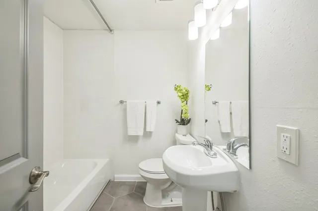 a bathroom with a sink a toilet and bathtub