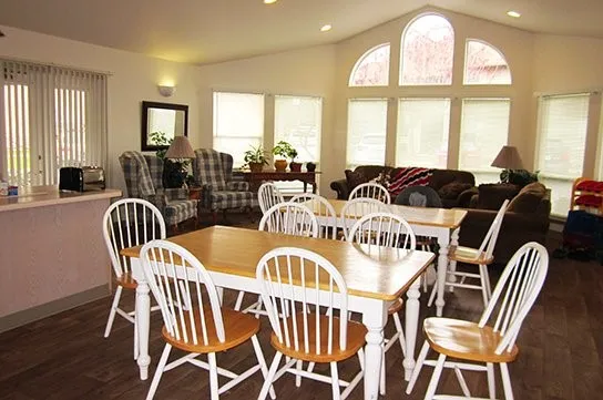 a view of a dining room with furniture a chandelier and wooden floor