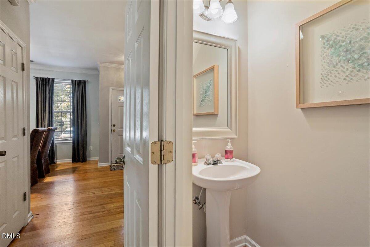 5710 Corbon Crest Lane Raleigh, NC 27612 - Photo 11 of 25 a bathroom with a sink a mirror and a shower