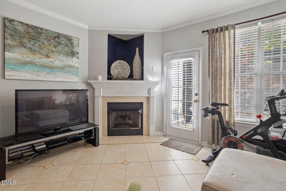 5710 Corbon Crest Lane Raleigh, NC 27612 - Photo 14 of 25 a living room with furniture a flat screen tv and a fireplace