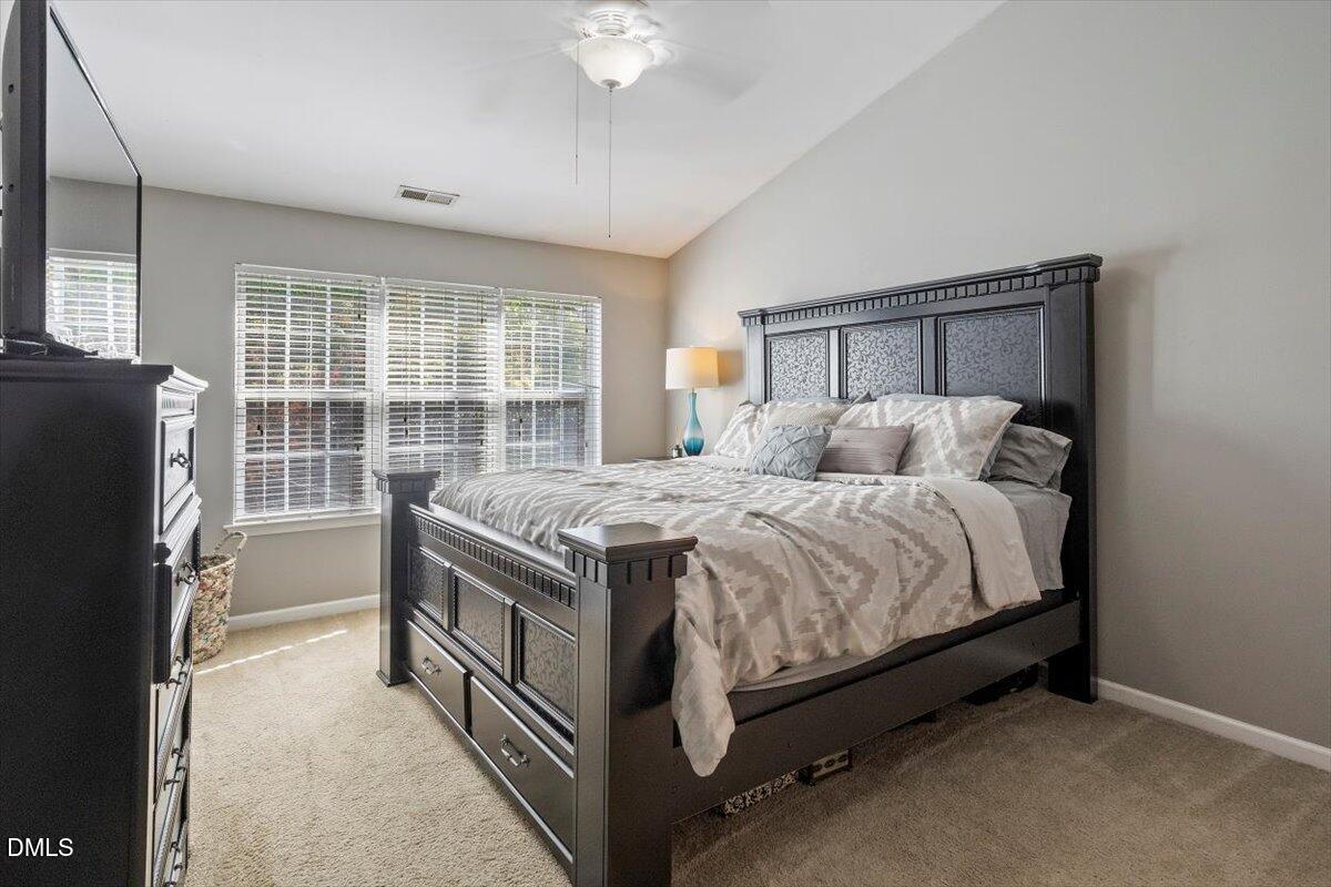 5710 Corbon Crest Lane Raleigh, NC 27612 - Photo 17 of 25 a bedroom with a bed and a window