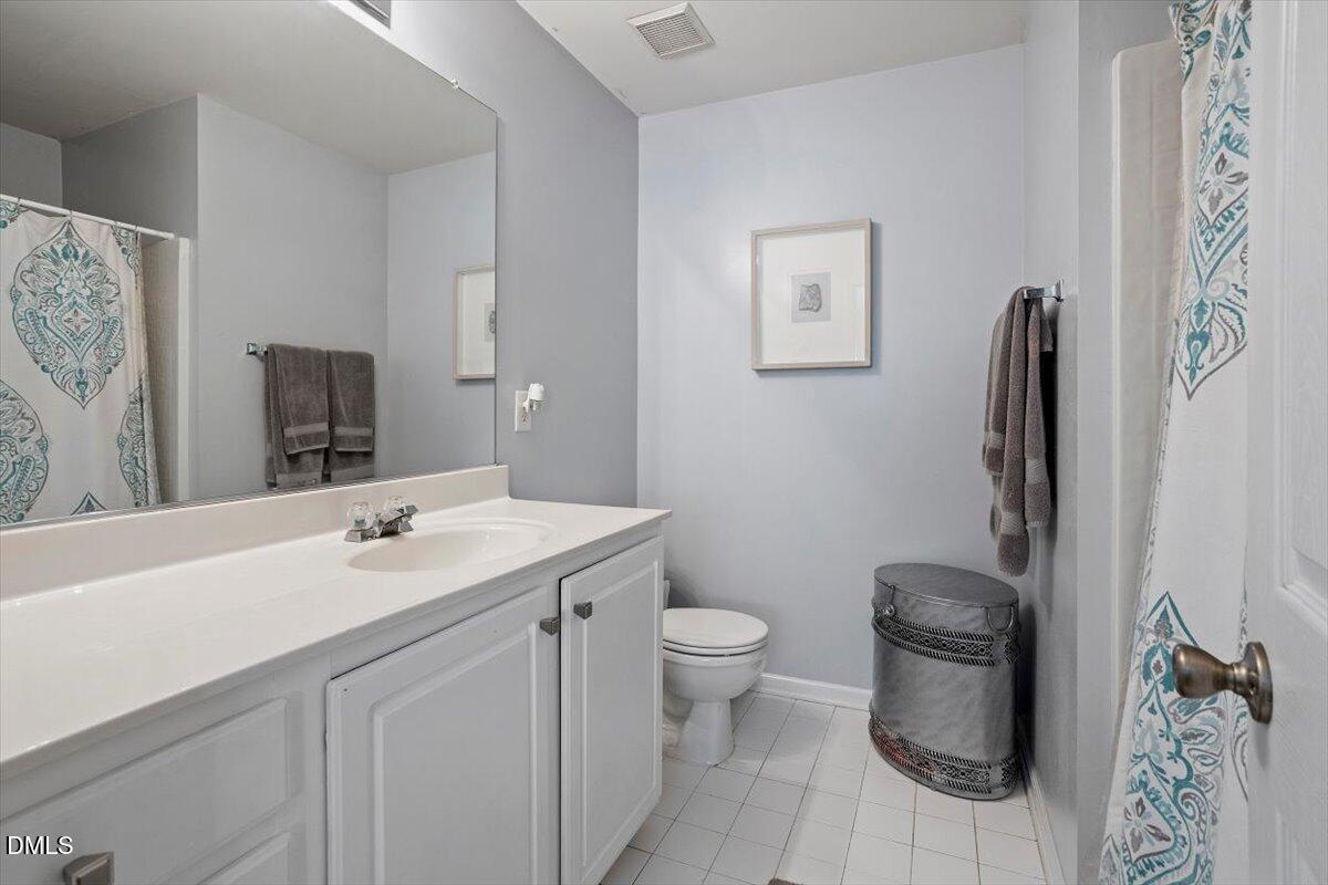 5710 Corbon Crest Lane Raleigh, NC 27612 - Photo 19 of 25 a bathroom with a toilet sink and mirror