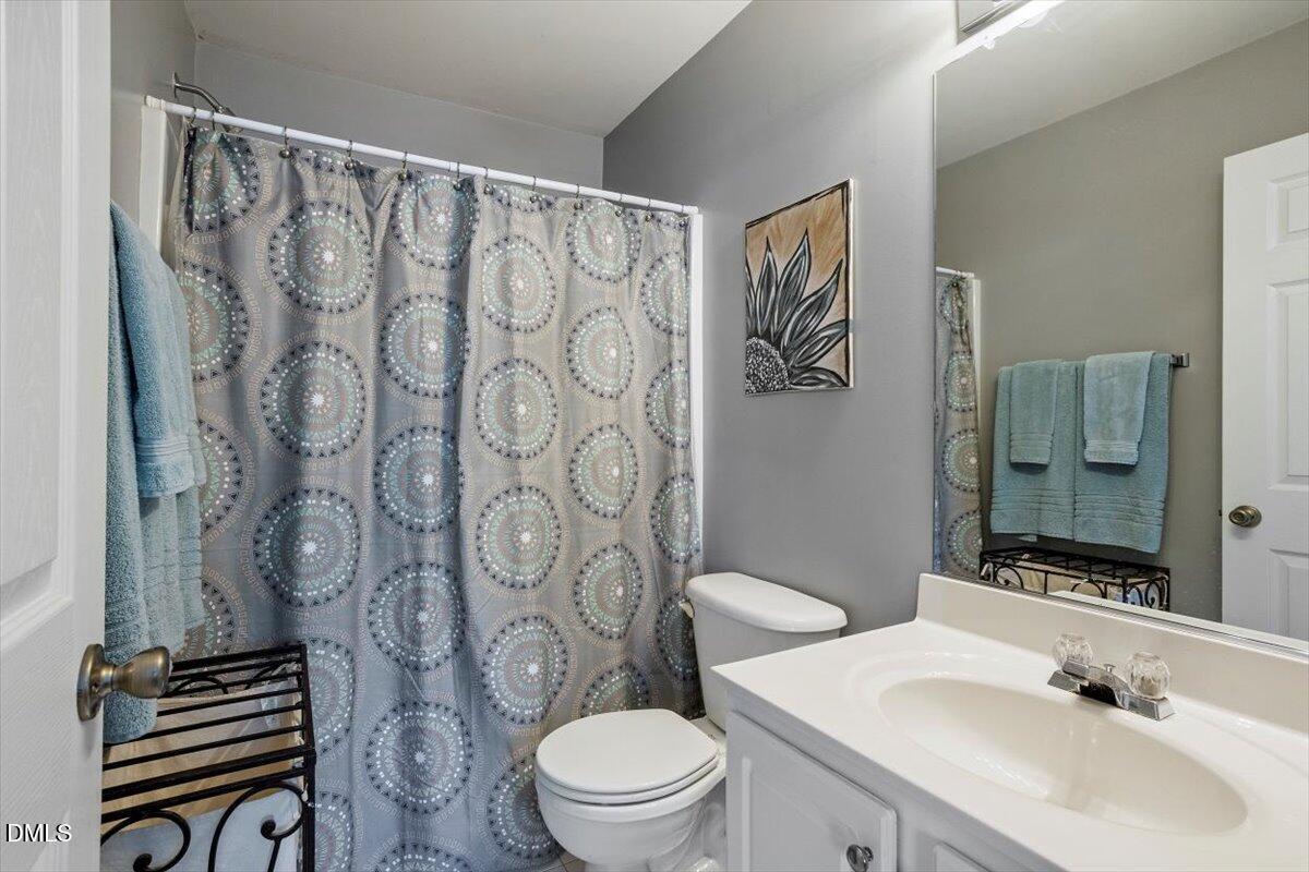 5710 Corbon Crest Lane Raleigh, NC 27612 - Photo 23 of 25 a bathroom with a sink toilet and shower