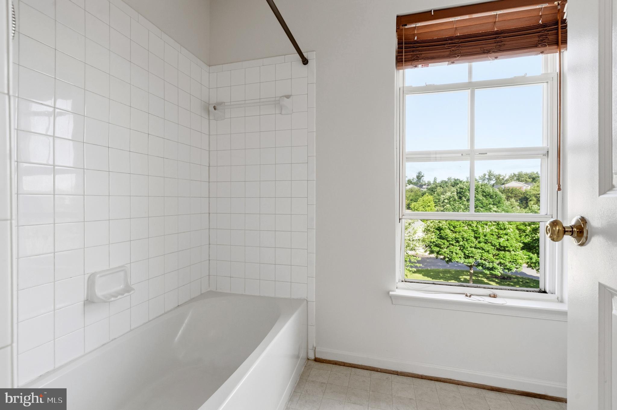 9227 Ribbon Falls Loop Bristow, VA 20136 - Photo 51 of 53 a bathroom with a bathtub and window