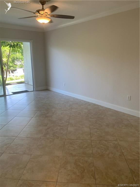 3129 Southeast Indian Street, Unit 3 Stuart, FL 34997 - Photo 2 of 10 wooden floor in an empty room with a window