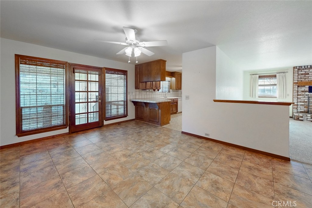 510 Indiana Street Gridley, CA 95948 - Photo 11 of 45 an empty room with chandelier fan and windows