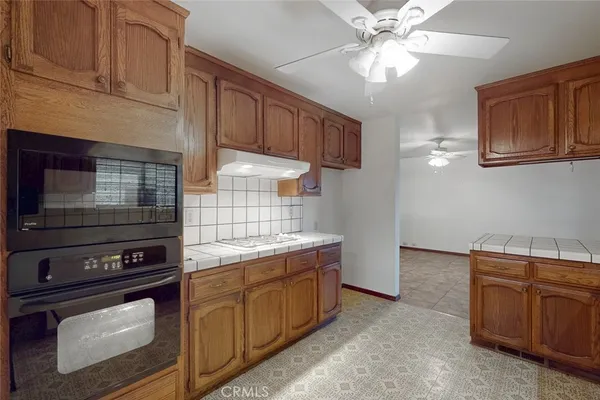 a kitchen with a stove oven and cabinets