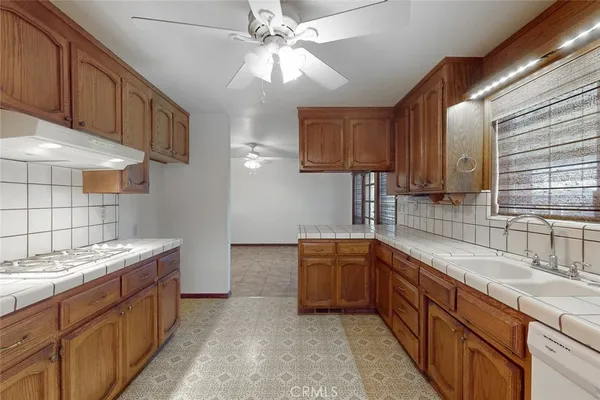 a kitchen with stainless steel appliances granite countertop a sink and a stove