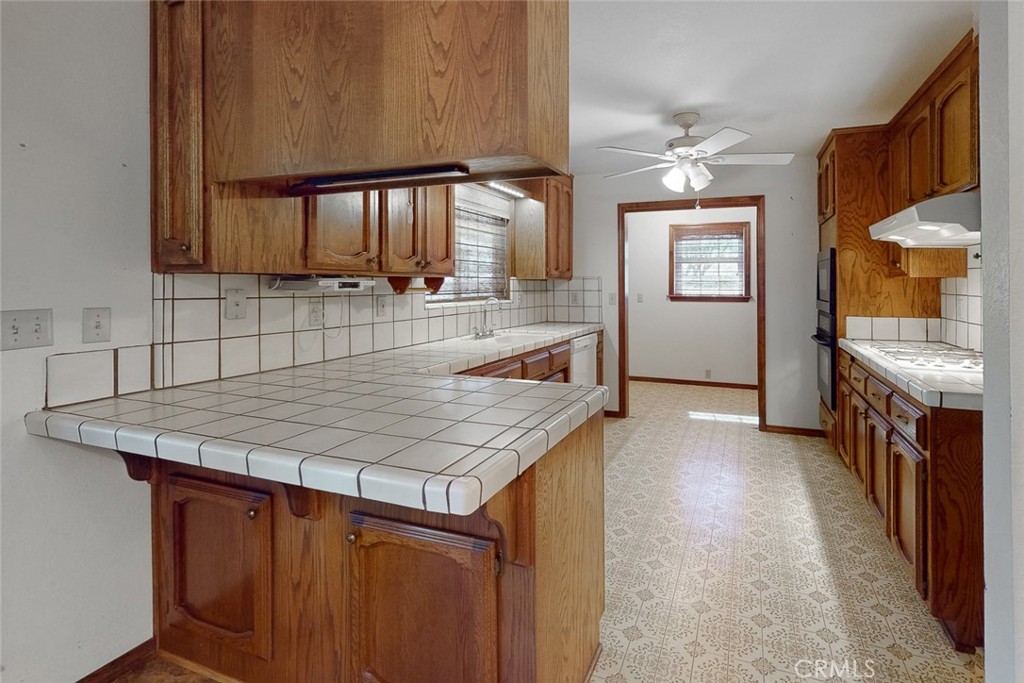 510 Indiana Street Gridley, CA 95948 - Photo 19 of 45 a kitchen with kitchen island a sink stove and cabinets