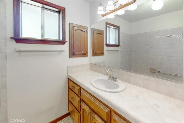 a bathroom with a sink a vanity and a mirror