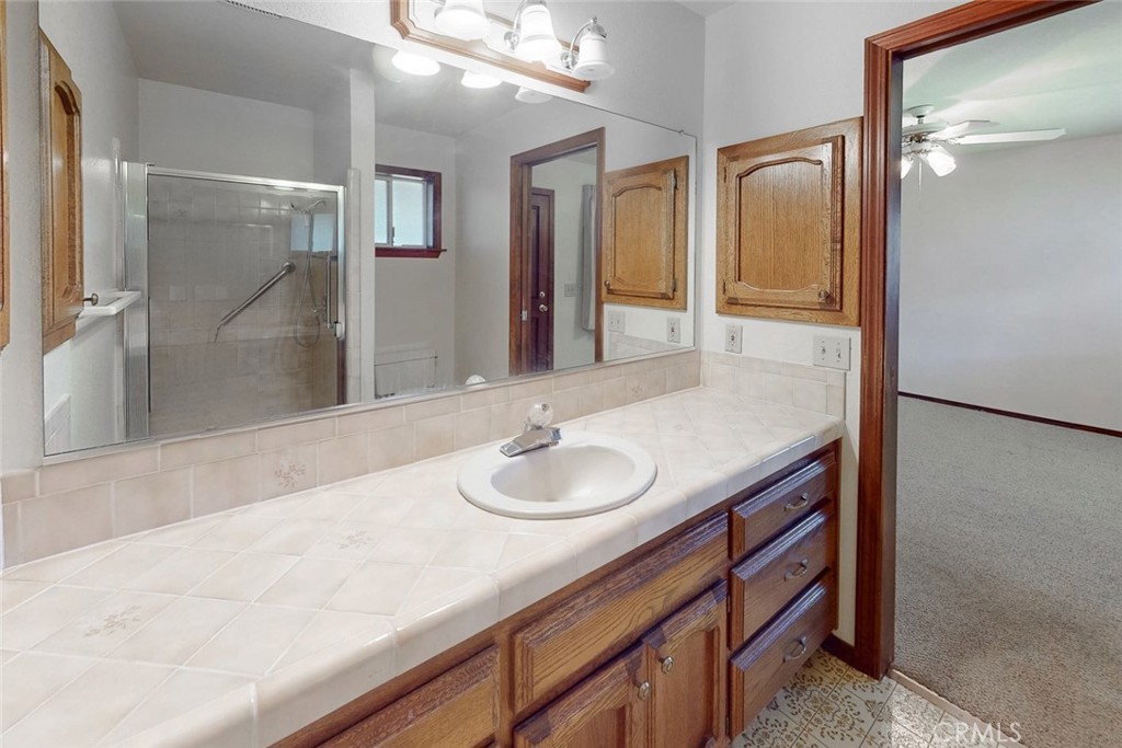 510 Indiana Street Gridley, CA 95948 - Photo 29 of 45 a bathroom with a granite countertop sink and a mirror