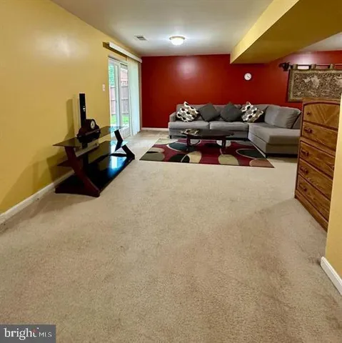 a living room with furniture a lamp and a potted plant