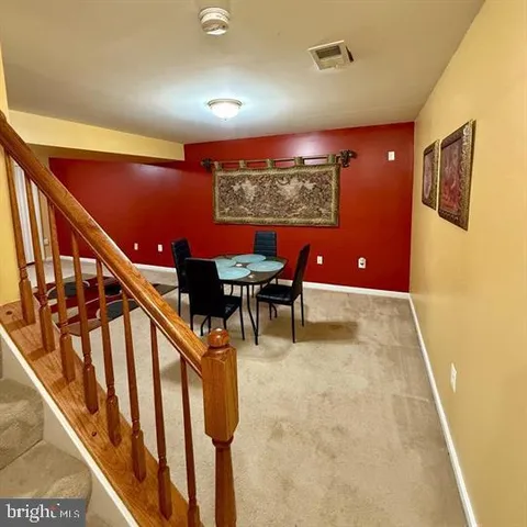 a view of a livingroom with furniture and staircase