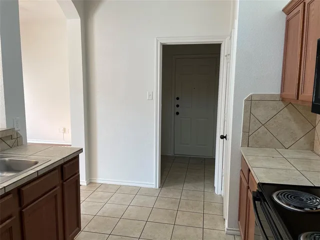 a kitchen with a sink stove and cabinets