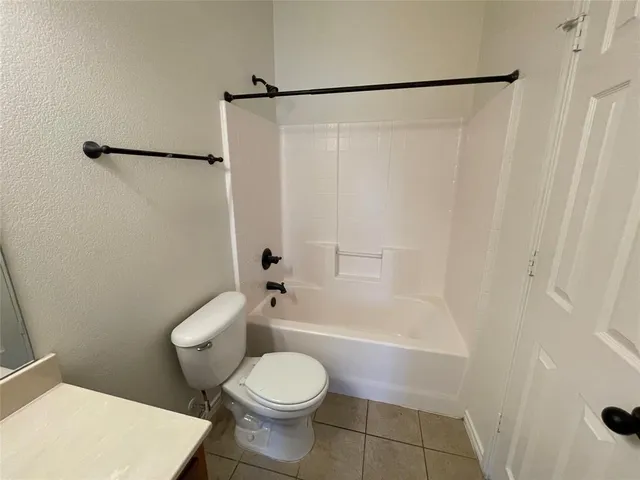 a bathroom with a toilet and a shower curtain