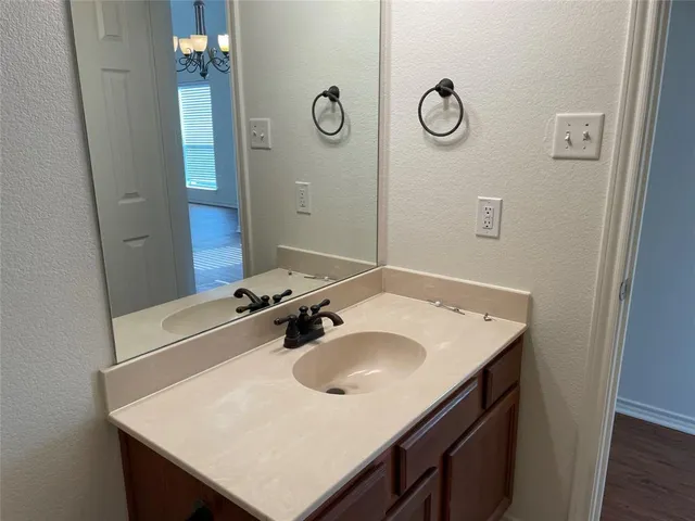 a bathroom with a sink vanity and a mirror