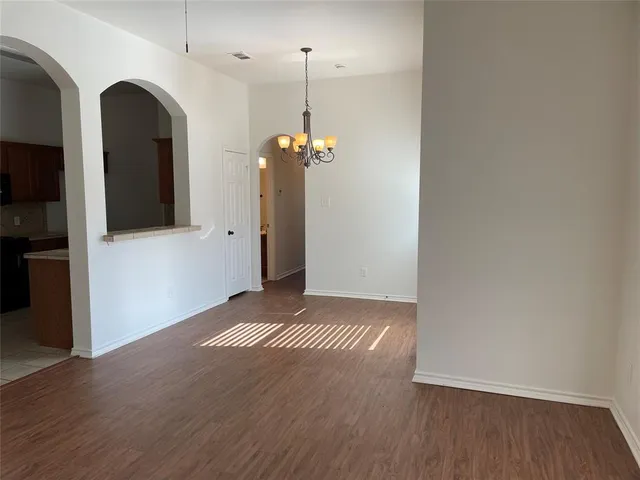 a view of a room with wooden floor