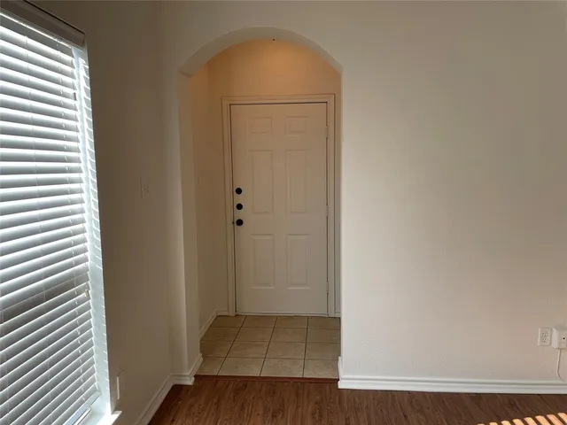 an empty room with wooden floor and closet