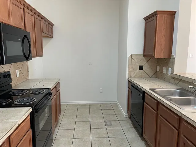 a kitchen with a sink stove and microwave