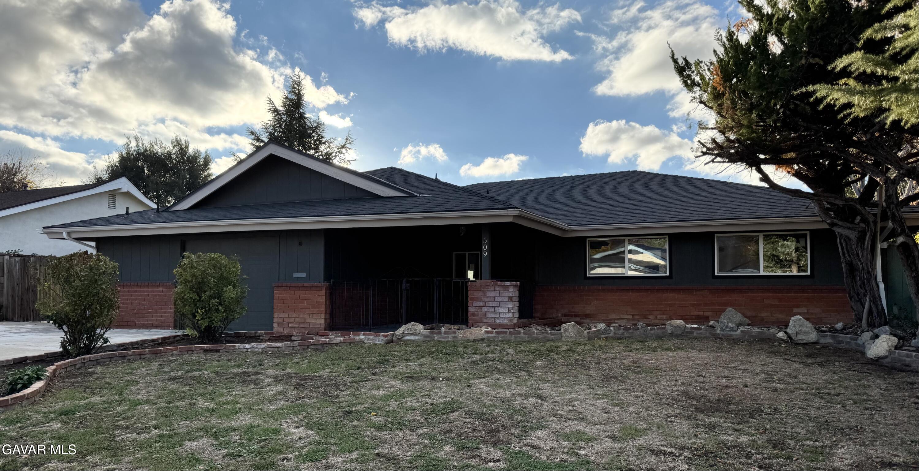 509 Oakwood Street Tehachapi, CA 93561 - Photo 1 of 1 a front view of a house with a yard