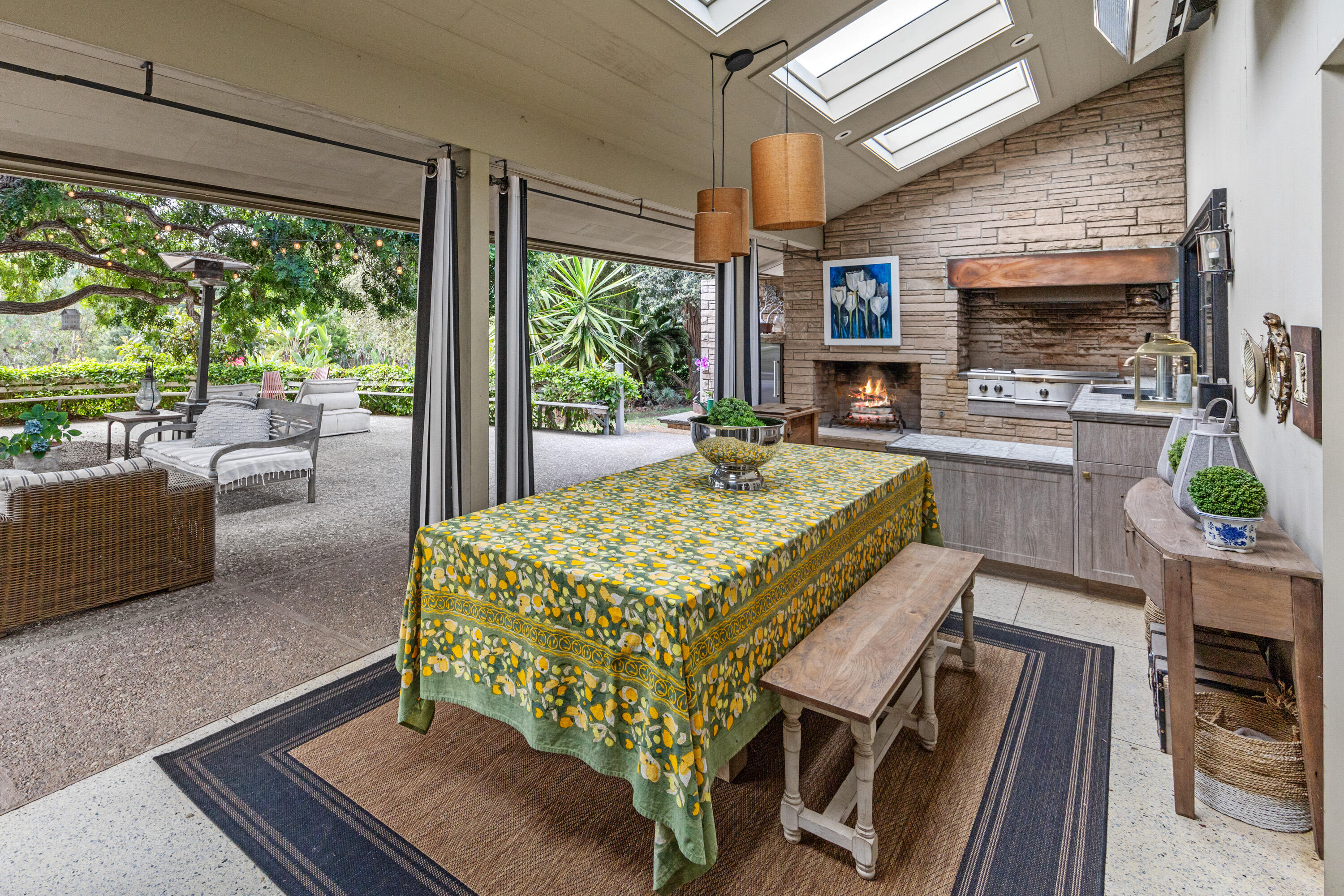 785 Carosam Road Santa Barbara, CA 93110 - Photo 22 of 46 a bed sitting in a living room with a fireplace a flat screen tv and a large window