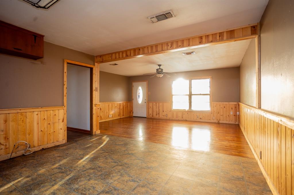 1414 Rice Avenue Gainesville, TX 76240 - Photo 7 of 21 a view of empty room with wooden floor and fan