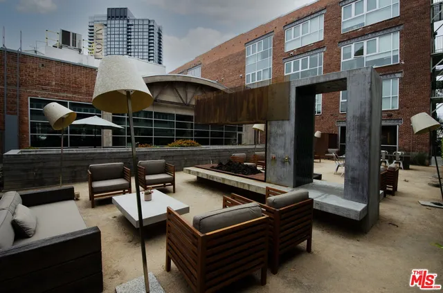 a outdoor living space with patio furniture and a fireplace