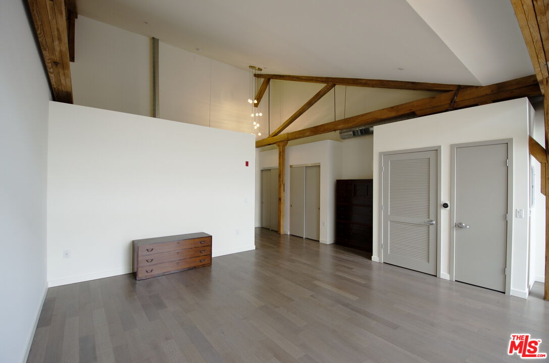 527 Molino Street, Unit 217 Los Angeles, CA 90013 - Photo 6 of 28 a view of an empty room with wooden floor